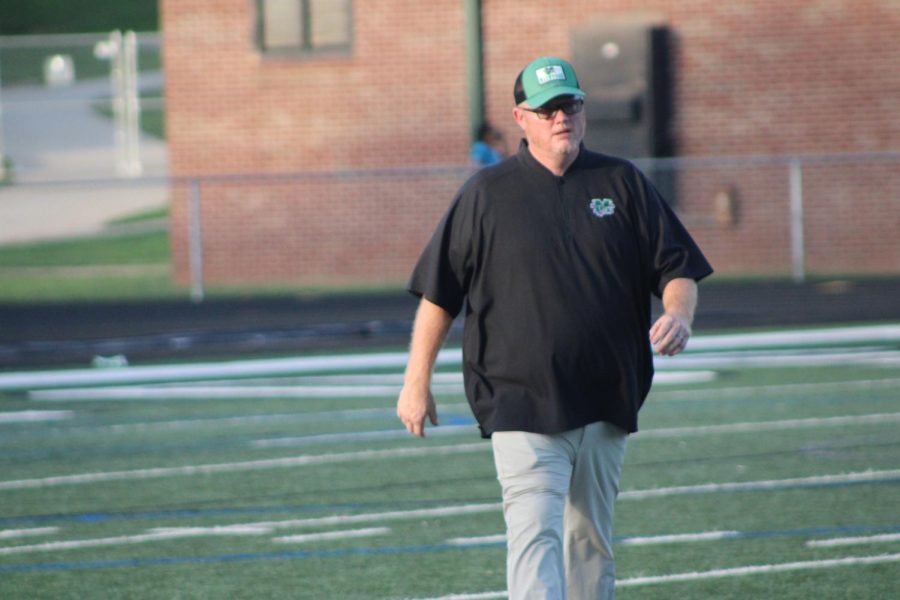 Head Coach Derek Smith takes the field alongside the Chiefs at the Aug. 28 game against Hampton. 