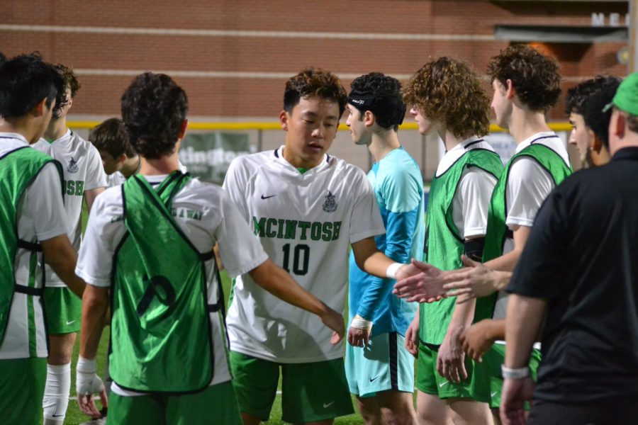 Mathew Yi (12) high-fives the team in preparation to start the game against Decatur on Jan. 31, 2023.
