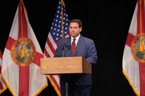 Governor Ron DeSantis standing at a podium (https://flgov.smugmug.com/Governor-Ron-DeSantis/2023/February/Rural-Broadband-Santa-Rosa-County/i-c2ztbTV/A)