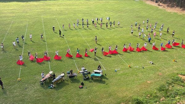 The view from the tower of the Spirit of McIntosh Marching Band practicing on what is currently their practice field. Director of Bands, Barbara Baker, center, steps in as backfield conductor near the 50-yard line one afternoon at practice in Aug.. 