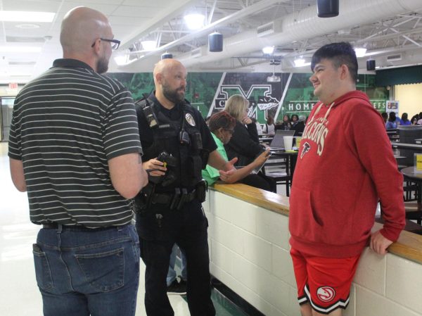 SRO Thomas Conover talks with a student and Vice Principal Bob Rice during lunch.
