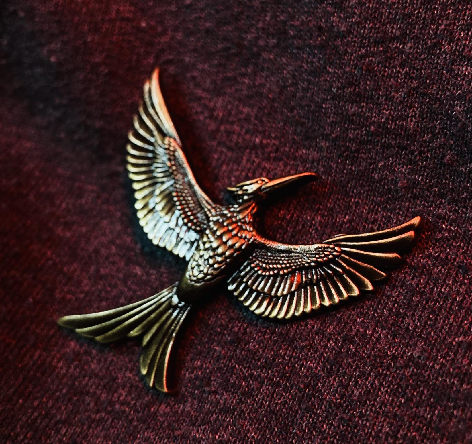 The Mockingjay pin paying tribute to the symbol of the rebellion from the original Hunger Game films