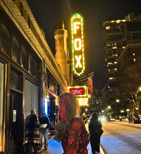Staff writer August Moss standing in front of the Fabulous Fox on her way to see Hamilton. Image edited using Canva.