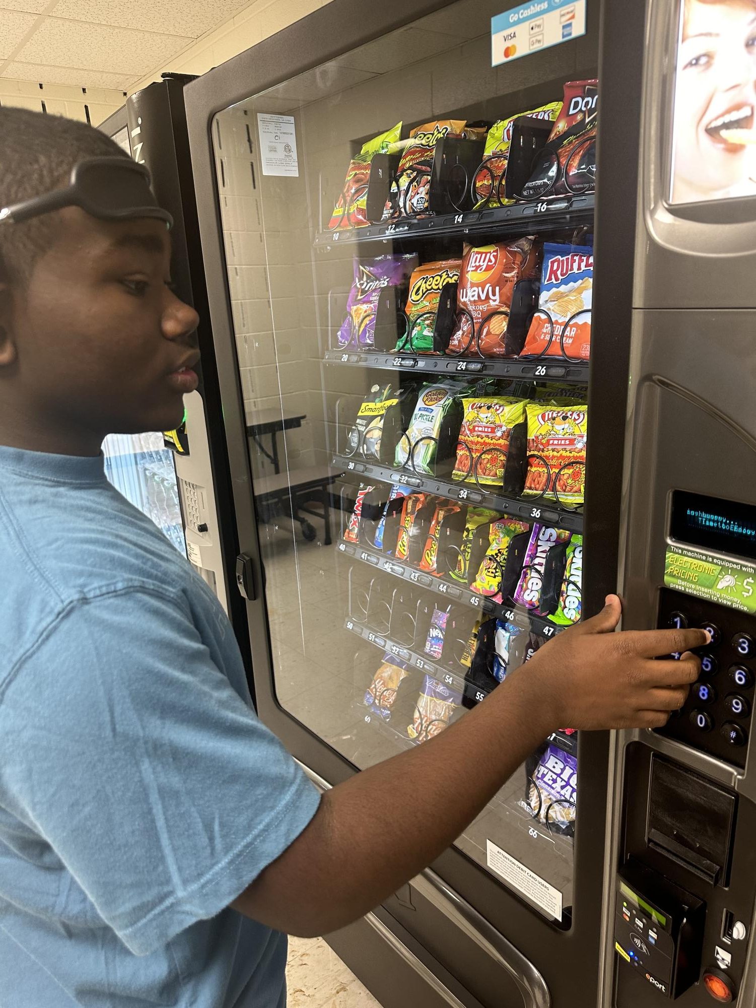 Sophomore Cj Boxhill  getting a snack from the vending machine. 