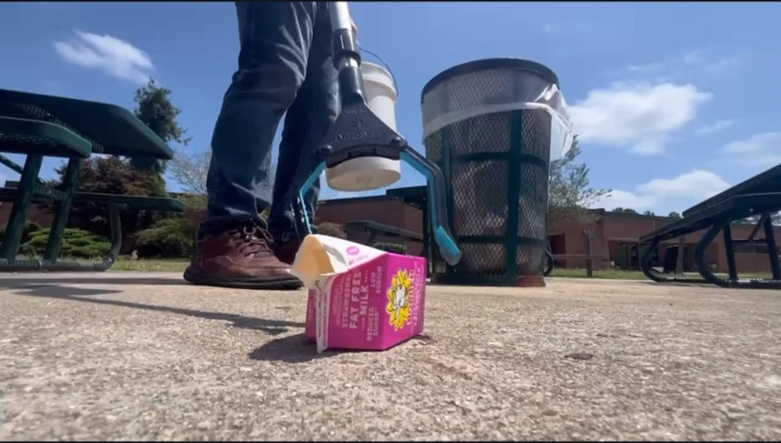 Ledford in the courtyard, picking up leftover trash after C lunch.  “I come out after all four lunch periods to pick up trash,” Ledford said. 