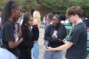 On Tues., Oct. 2, students in Andrew Clink's AP Psychology classes participated in the "Sensory Fair" in the courtyard.  Testing their vestibular system, seniors Naomi Simeon, blank and Khilah Peavy close their eyes and try to point to where the program says.   