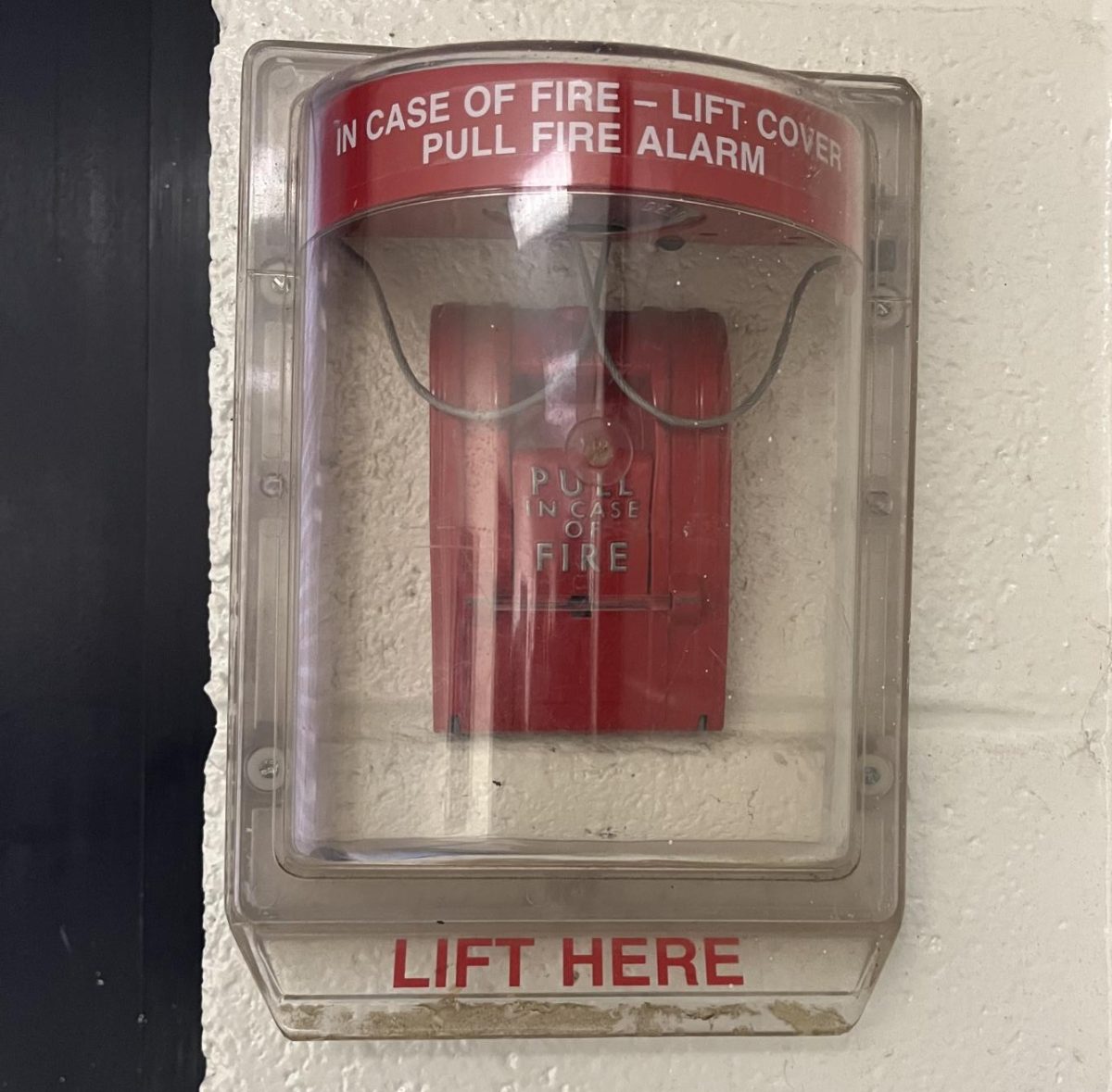 Image of a covered fire alarm in the school building. Photo by Nyla Kerr.