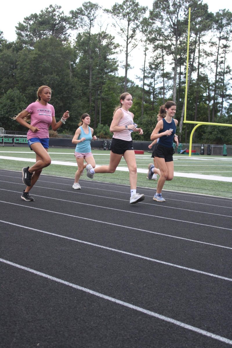 Girls Cross Country running the track during a September practice. Photo by Mikayla Santiago