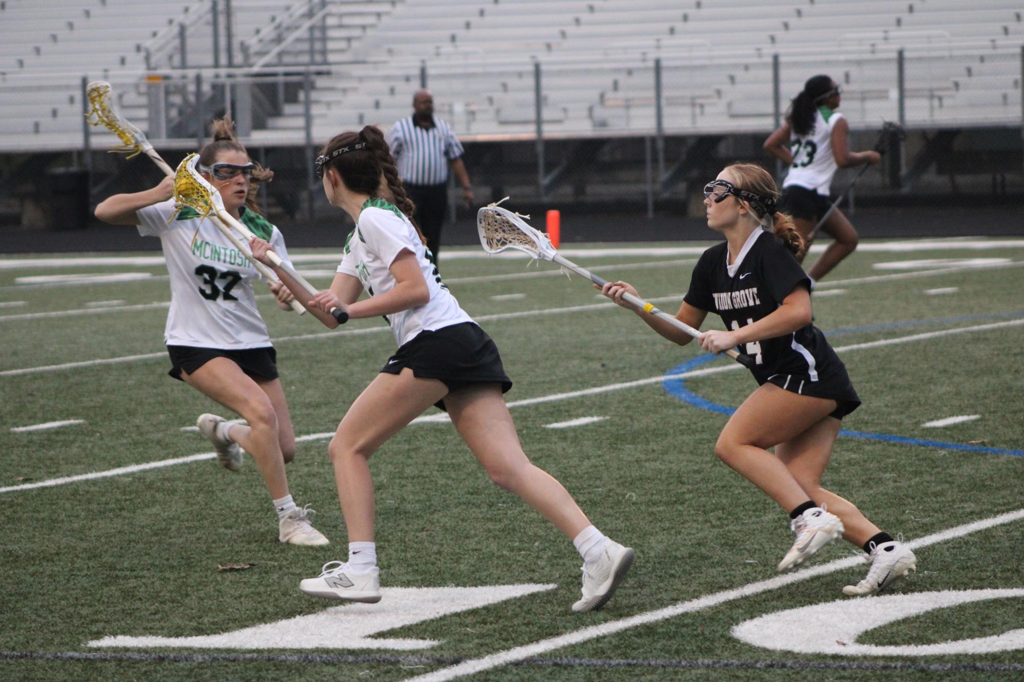 Varsity girls' lacrosse playing against Union Grove at McIntosh High School.