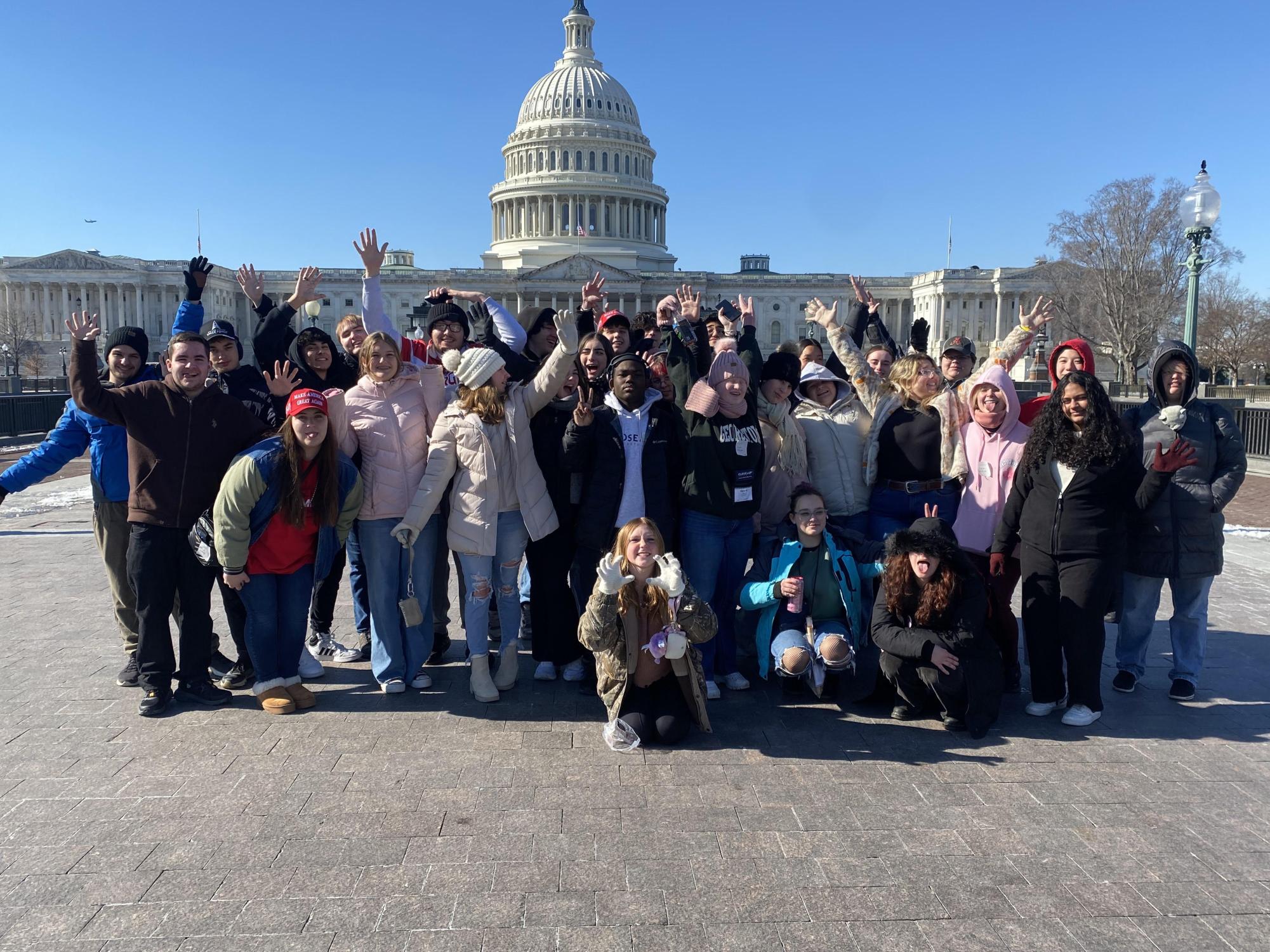 Close up trip attendees standing in front of the Capitol in Washington D.C.