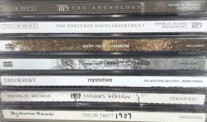 A photo capturing multiple of Taylor Swift’s albums in the CD version.