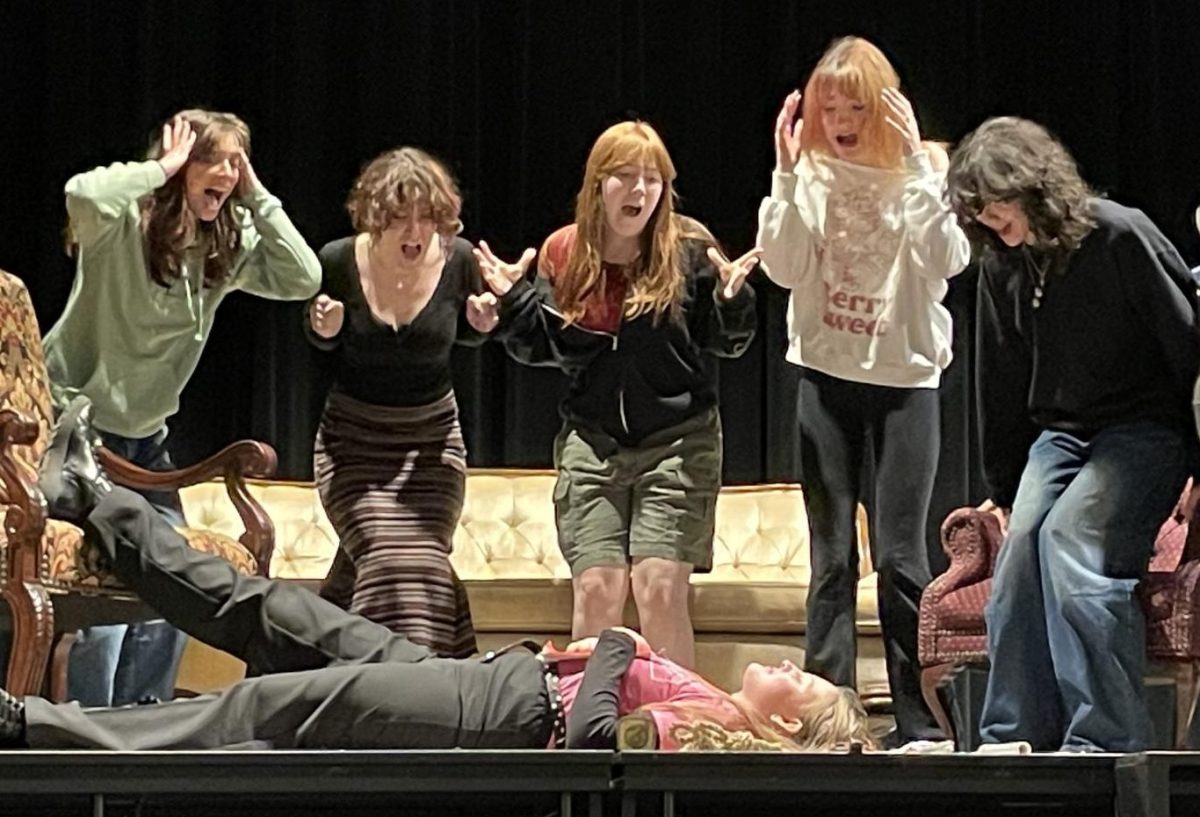 McIntosh Advanced Drama rehearses for play "Clue" on March 19. Karina Nirenberg, Abby Greenstein, Katie Ford and Alexandria McCormick react to the "death" of Addy Blair, who plays Wadsworth.