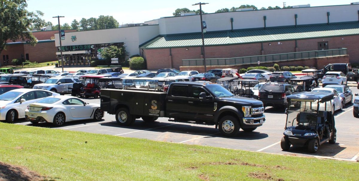 A construction truck taking up three parking spots in the McIntosh parking lot.