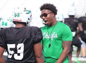 Coach Iyante Price motivates a player on the field during a September afternoon practice. 