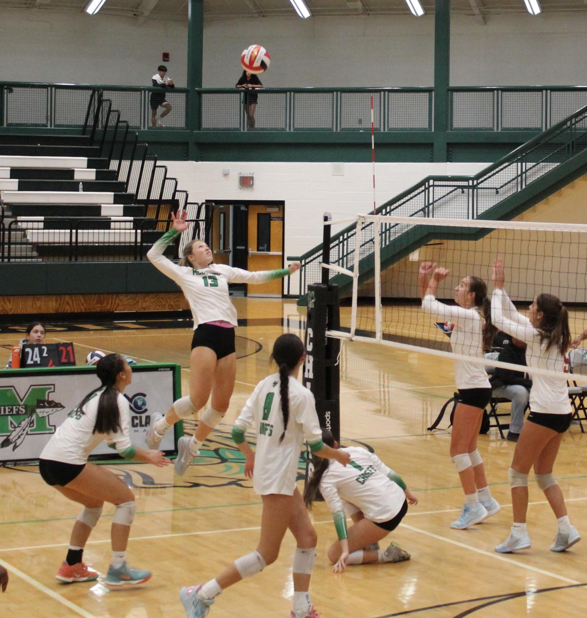 Outside and opposite hitter, Claudia Meditz (12), gets ready to score match point against Midtown high school.