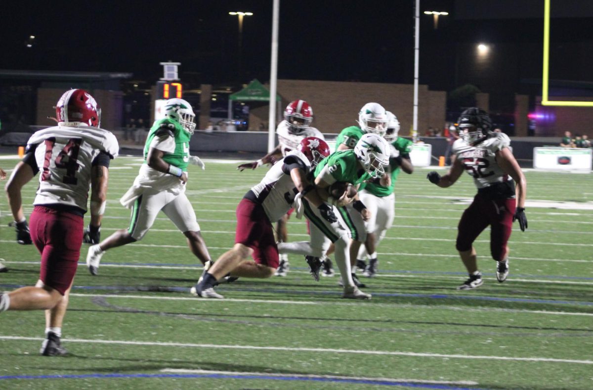 Senior Elijah Strader running for a touchdown attempt in the first half of the game.