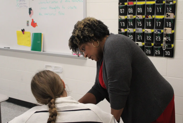 Picture of Felicia Gunn, helping a student with an english test