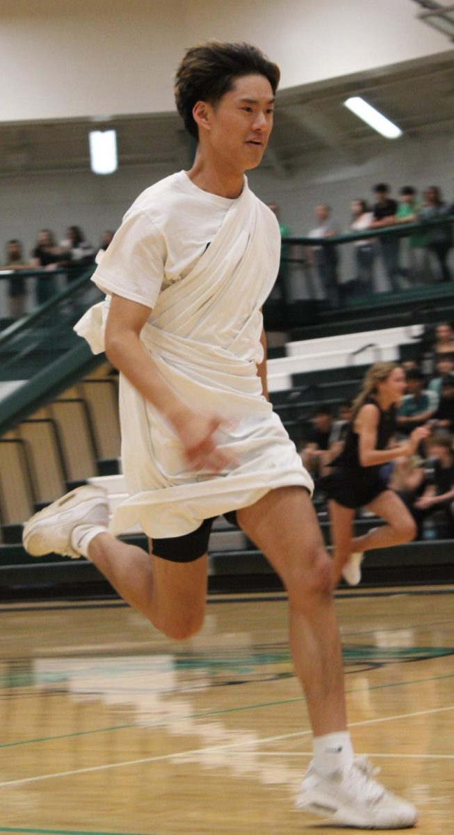Nathaniel De La Cruz (12) running to pop his team's balloon in the pep rally balloon relay.