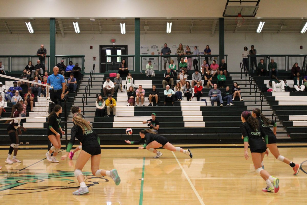 Senior Braelyn Ottolini lunges to keep the ball off of the ground.