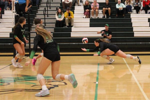 Senior Braelyn Ottolini lunges to keep the ball off of the ground.