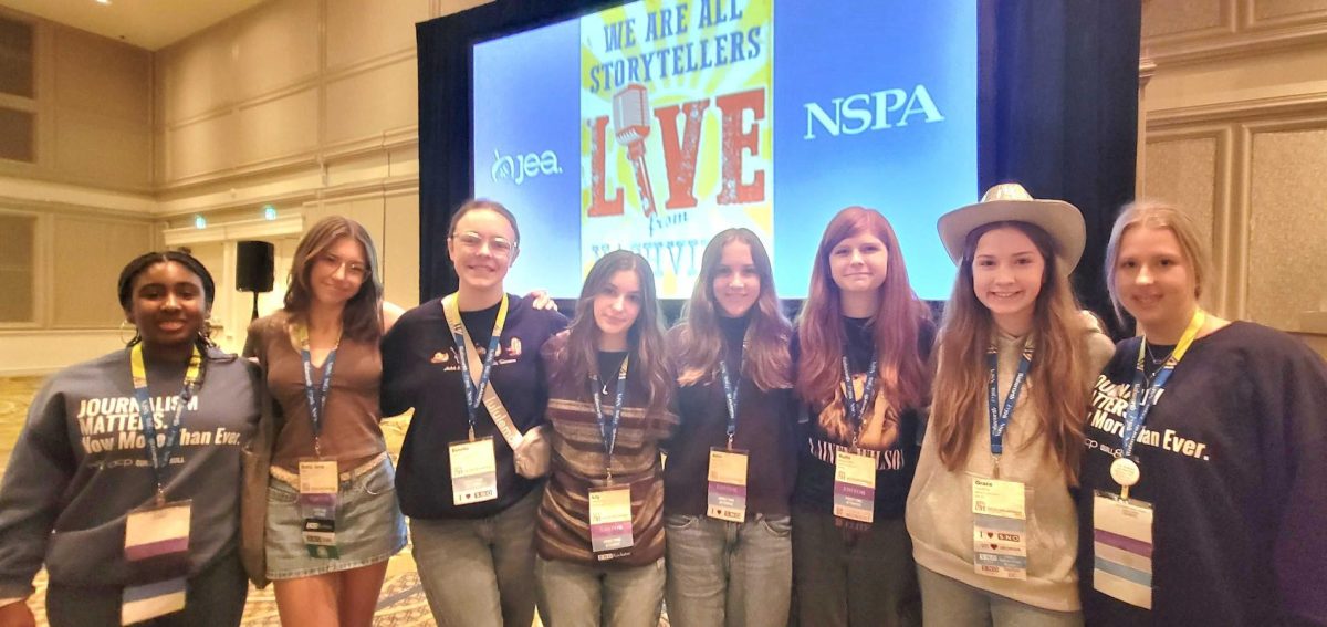 After the awards ceremony on the last day of the convention, the Trail staff takes a picture in front of the NSPA sign. Photo by Shanon Woolf