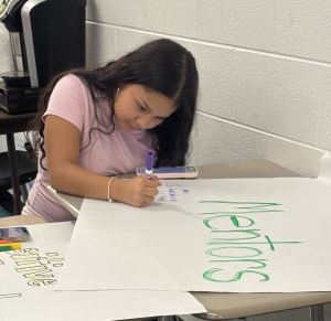 Freshman Destiny Perez at a Sources of Strength meeting writing their strengths under different categories