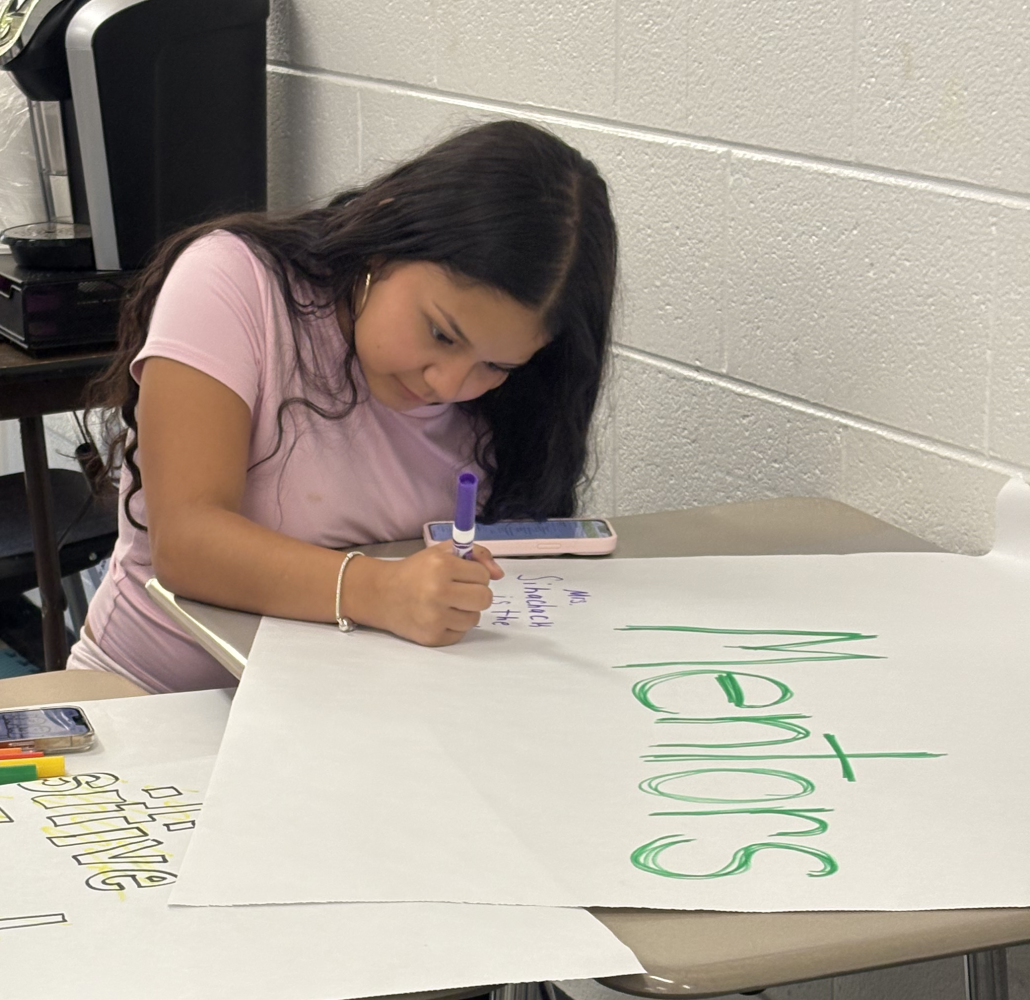 Freshman Destiny Perez at a Sources of Strength meeting writing their strengths under different categories
