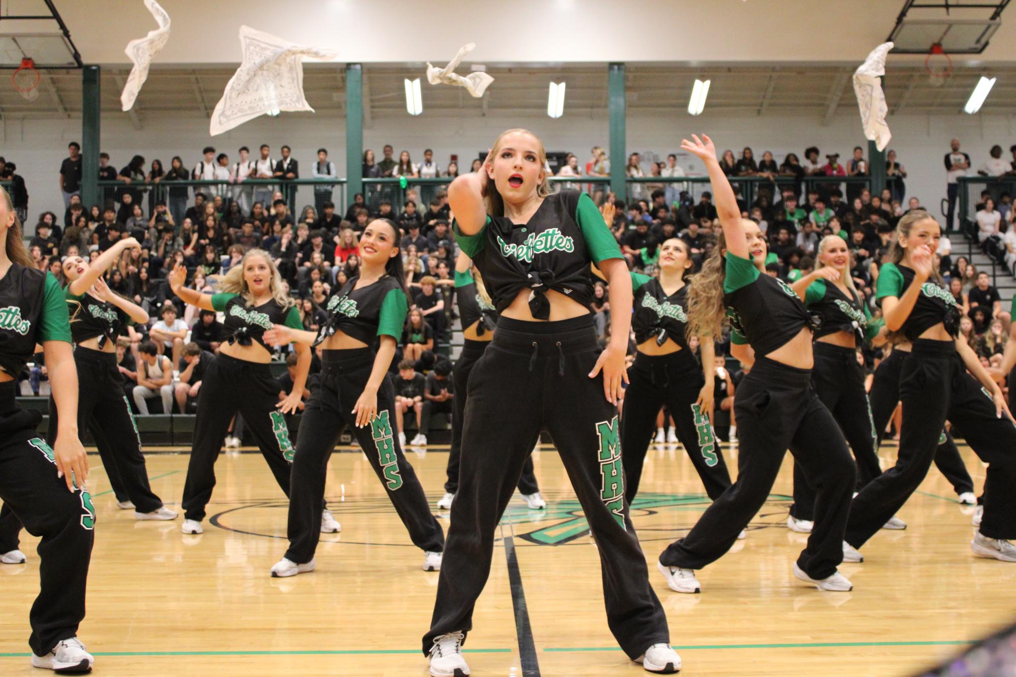 The top photo won the 2025 All-Georgia Award for Sports Photography. Congratulations to Yasemin Kalpakci. Picture of Chiefettes mid pep rally, throwing their towels in the air and posing.