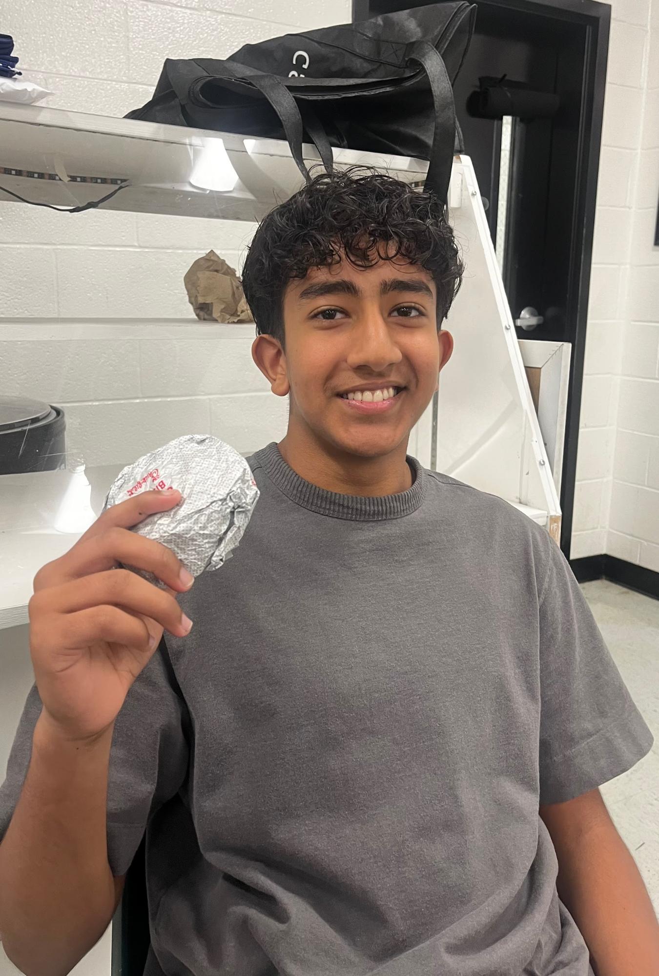 Rayan Samnani excited to eat the chicken biscuit he bought from the FBLA