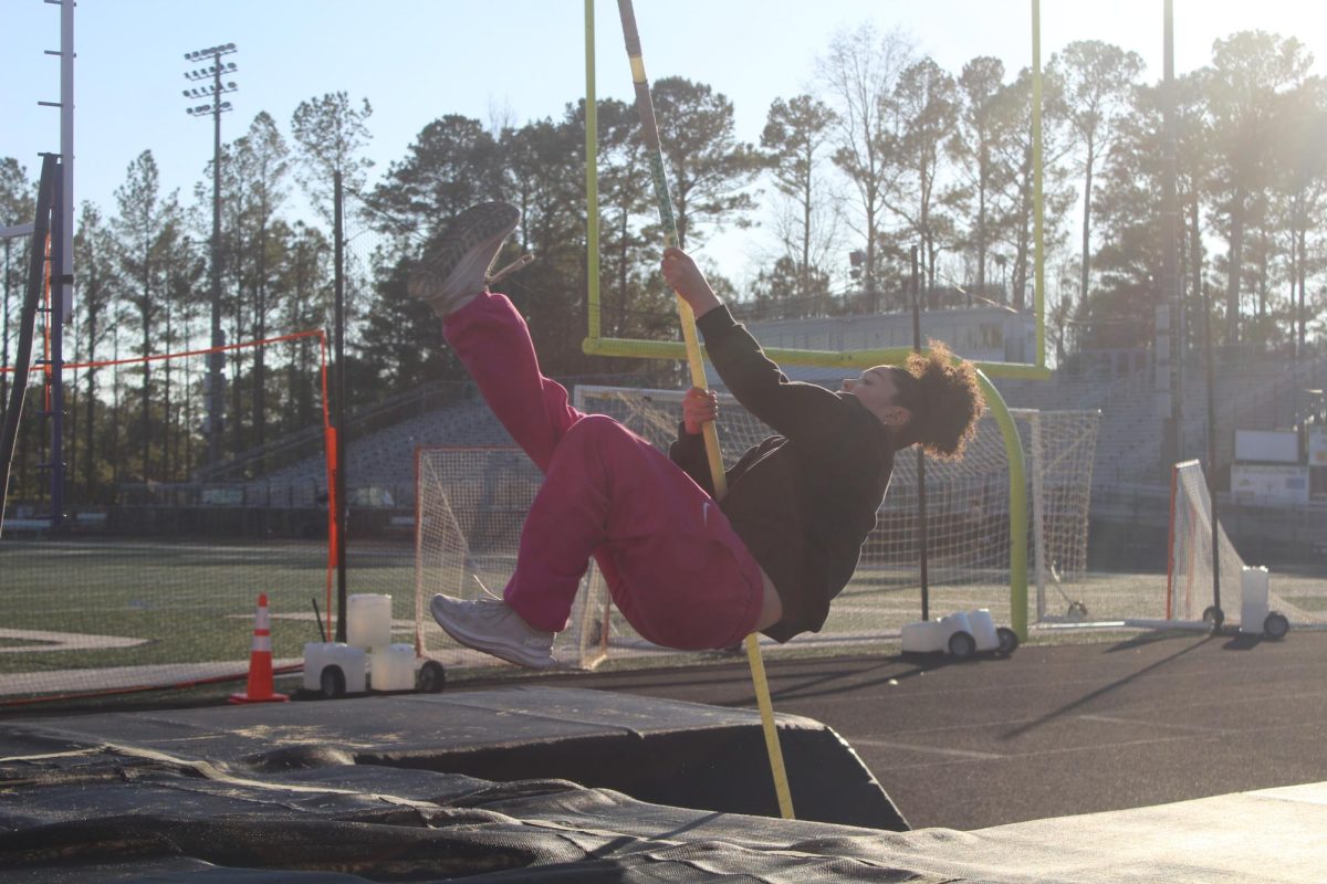  Junior Hanna Mallard works on her pole vaulting skills during practice.