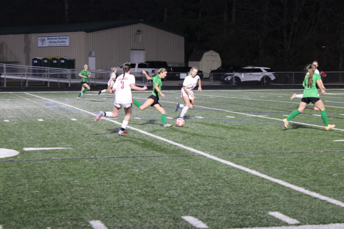 Senior Sophie Martos kicking the ball at the varsity girls soccer scrimmage vs. Walton High School on Feb. 6.  