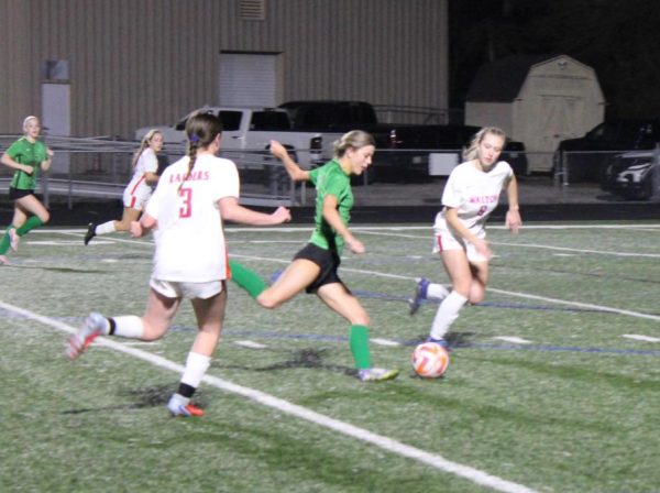Senior Sophie Martos kicking the ball at the varsity girls soccer scrimmage vs. Walton High School on Feb. 6.  
