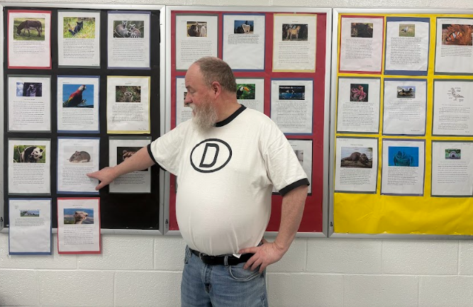 Kevin Keough in front of projects made by his German students 