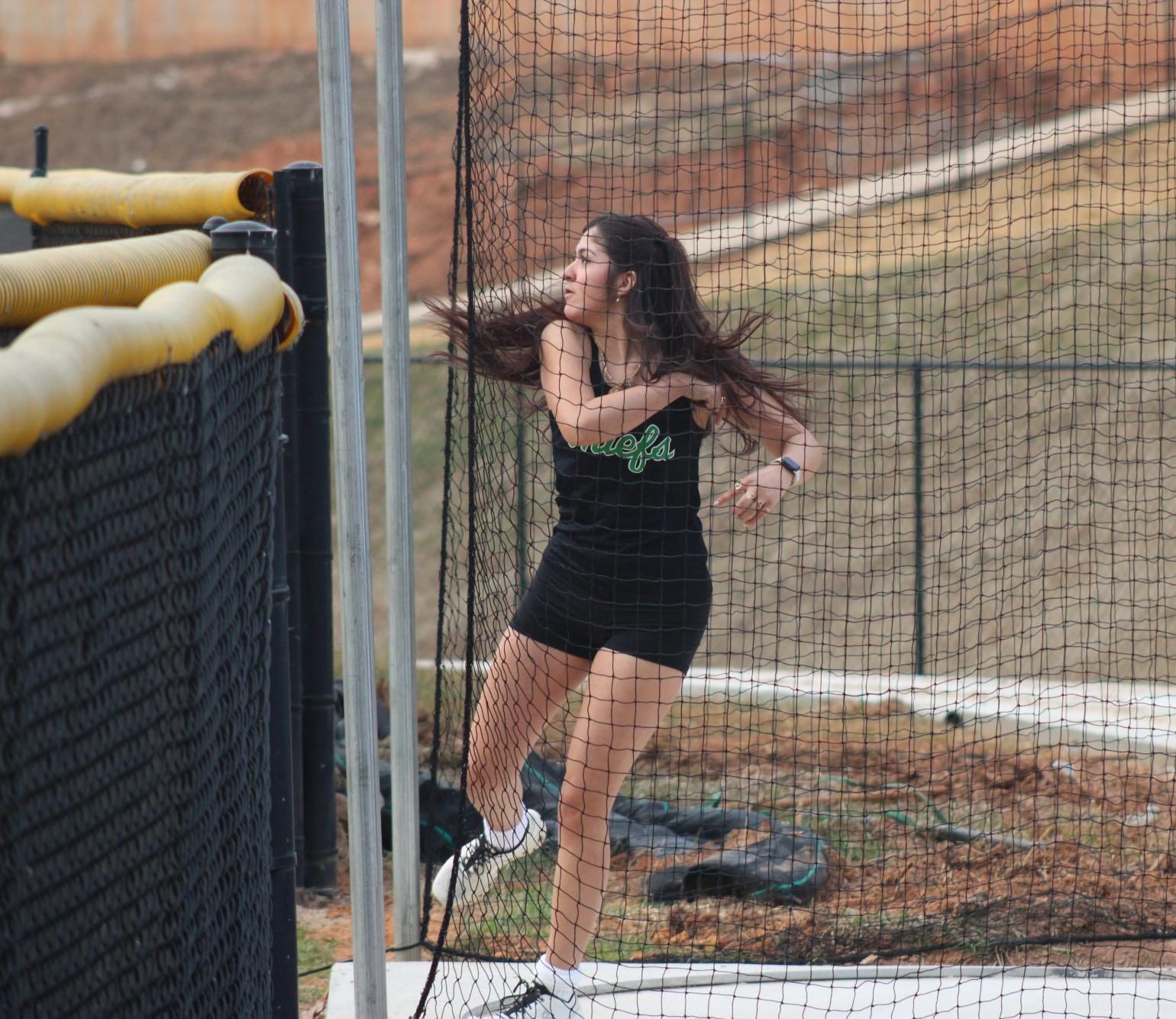 Junior Genesis Salinas-Magana throws the disc at a meet.