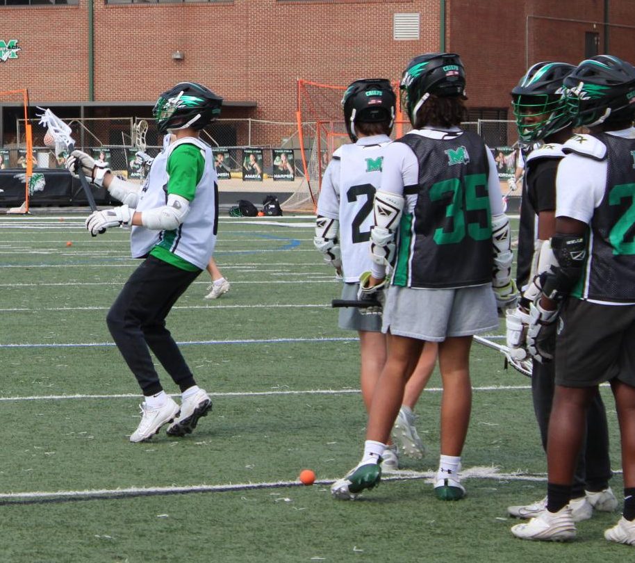 Players practice passing the ball while running up and down the field