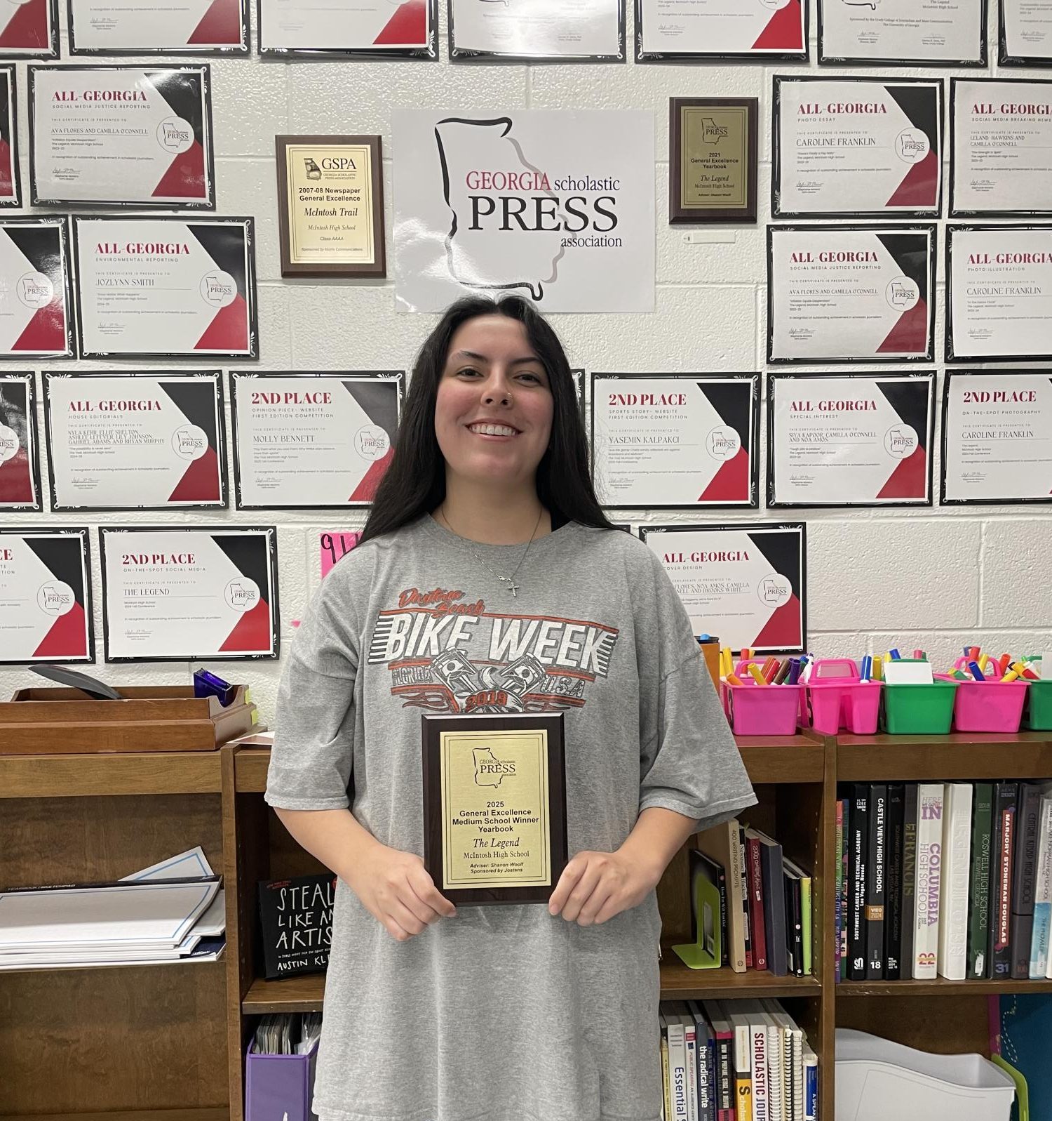 Legend yearbook Editor-In-Chief River Boyle (12) holding the plaque the staff earned in 2025. 