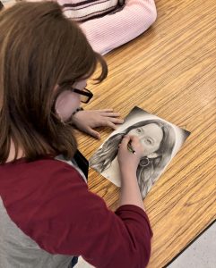 Sophomore Madison Elliott works on her drawing of actress Melissa O'Neil.